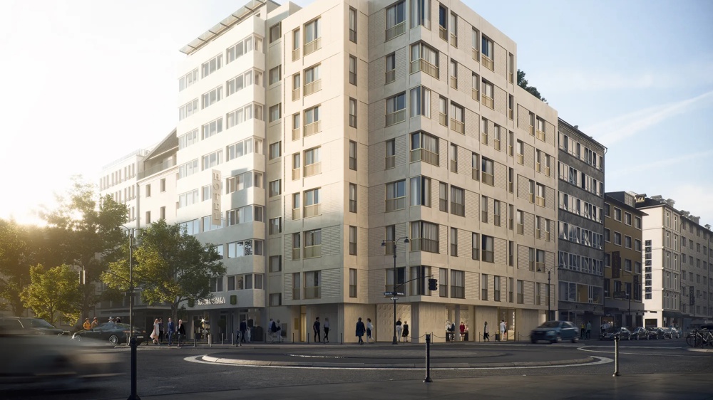 A modern, multi-storey building at a street corner with pedestrians and cars in the foreground.
