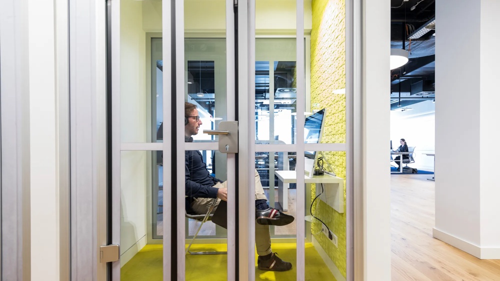 DigitalWerk. Telephone cell with computer monitor. A young man on the phone, video calling.
