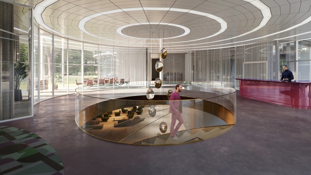 Moderner Raum mit runden Deckenlichtern, gläserner Wendeltreppe und einem Mann im Anzug.