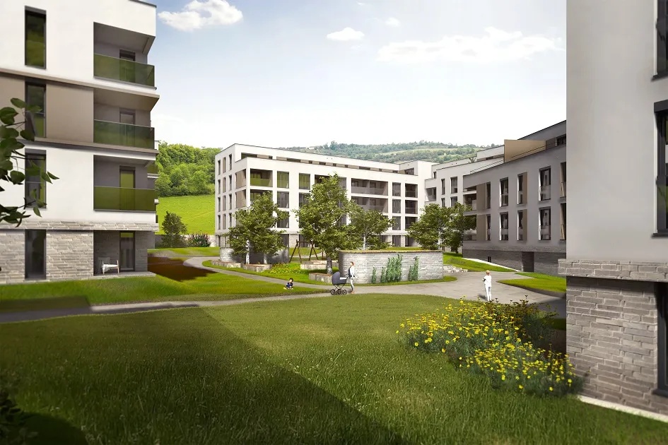 Moderne Wohngebäude mit grüner Wiese, Bäumen und Gehwegen; Personen gehen spazieren.
