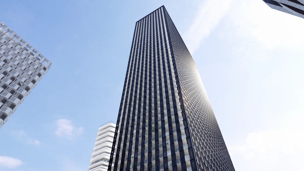 Visualisierung des DC Tower 2 in Wien aus der Froschperspektive – dunkle Glasfassade ragt in den blauen Himmel, flankiert von weiteren Hochhäusern der Donau City – ein hausInvest-Objekt.