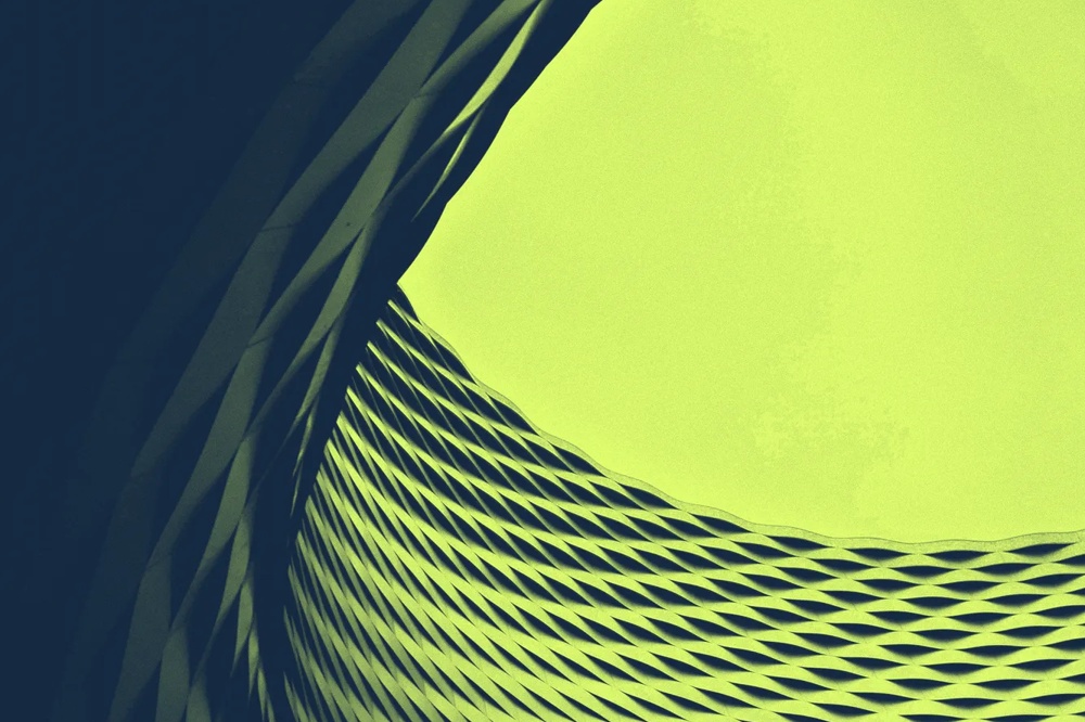 Geschwungene, grüne, gitterartige Struktur vor hellem Hintergrund.