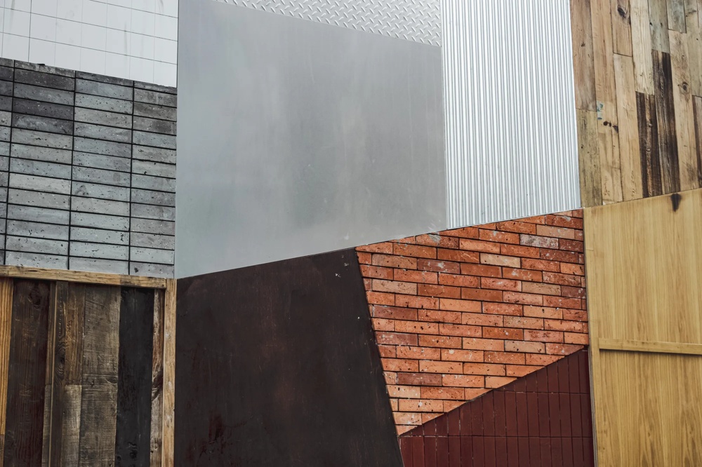 Different wall textures: Metal, brick, wood and concrete arranged in geometric shapes.