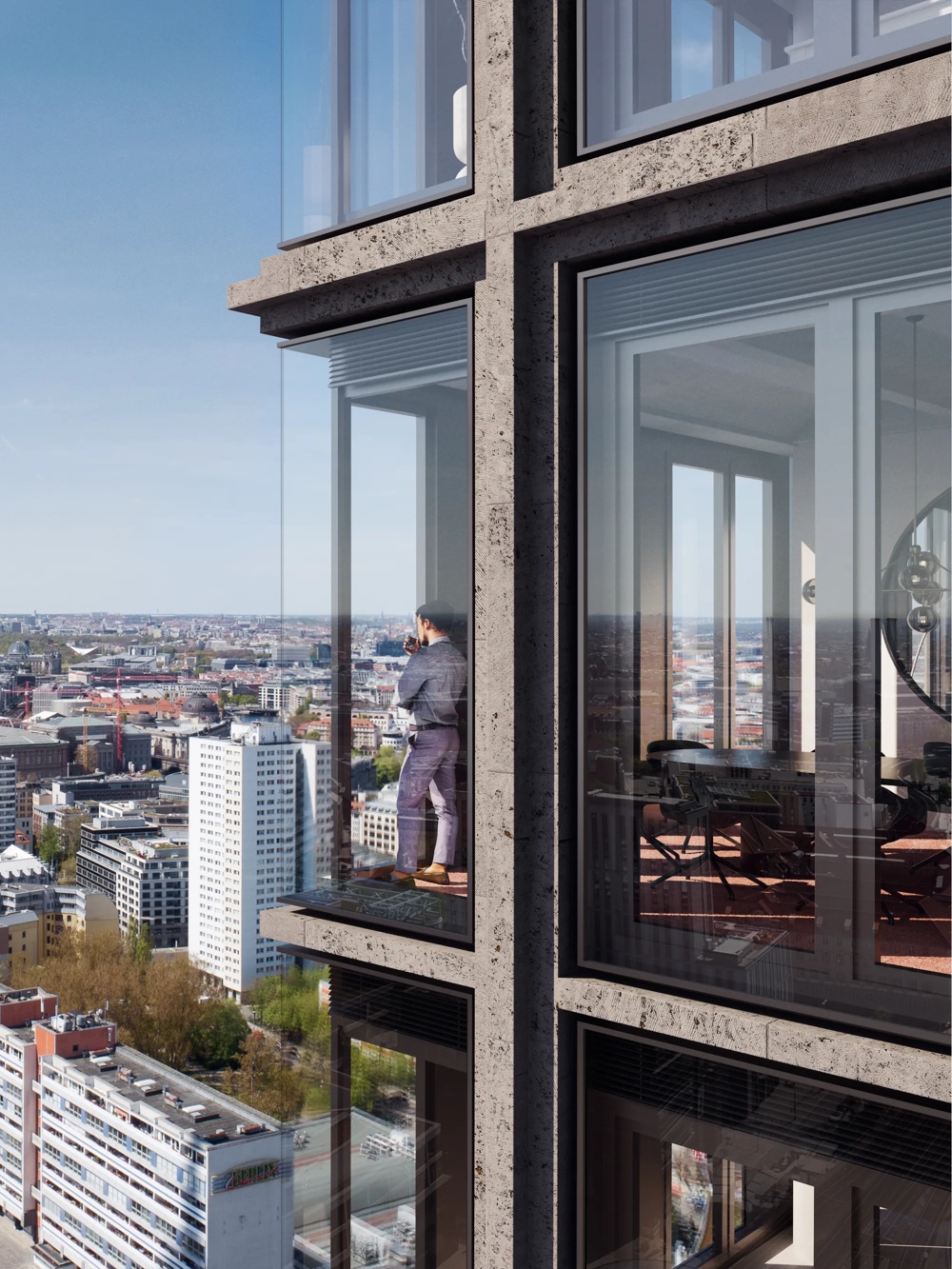 A man standing on a glazed balcony of a high-rise building with a view of a cityscape in a clear sky.