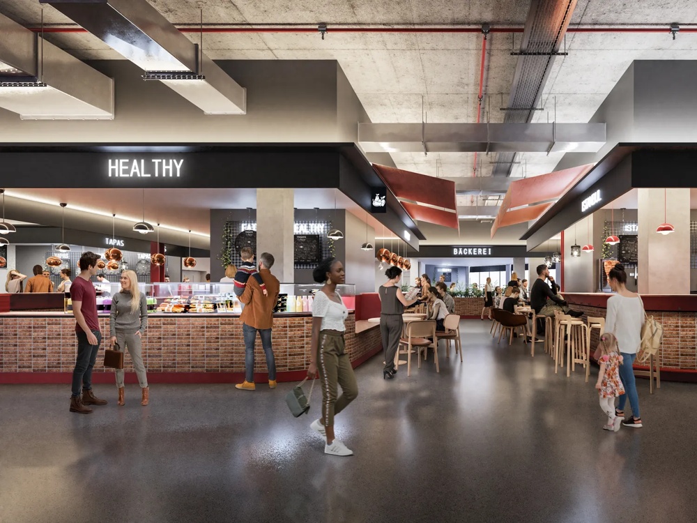 Menschen in einer modernen Markthalle mit Essensständen, darunter "Healthy" und "Istanbul", in lebendiger Atmosphäre.